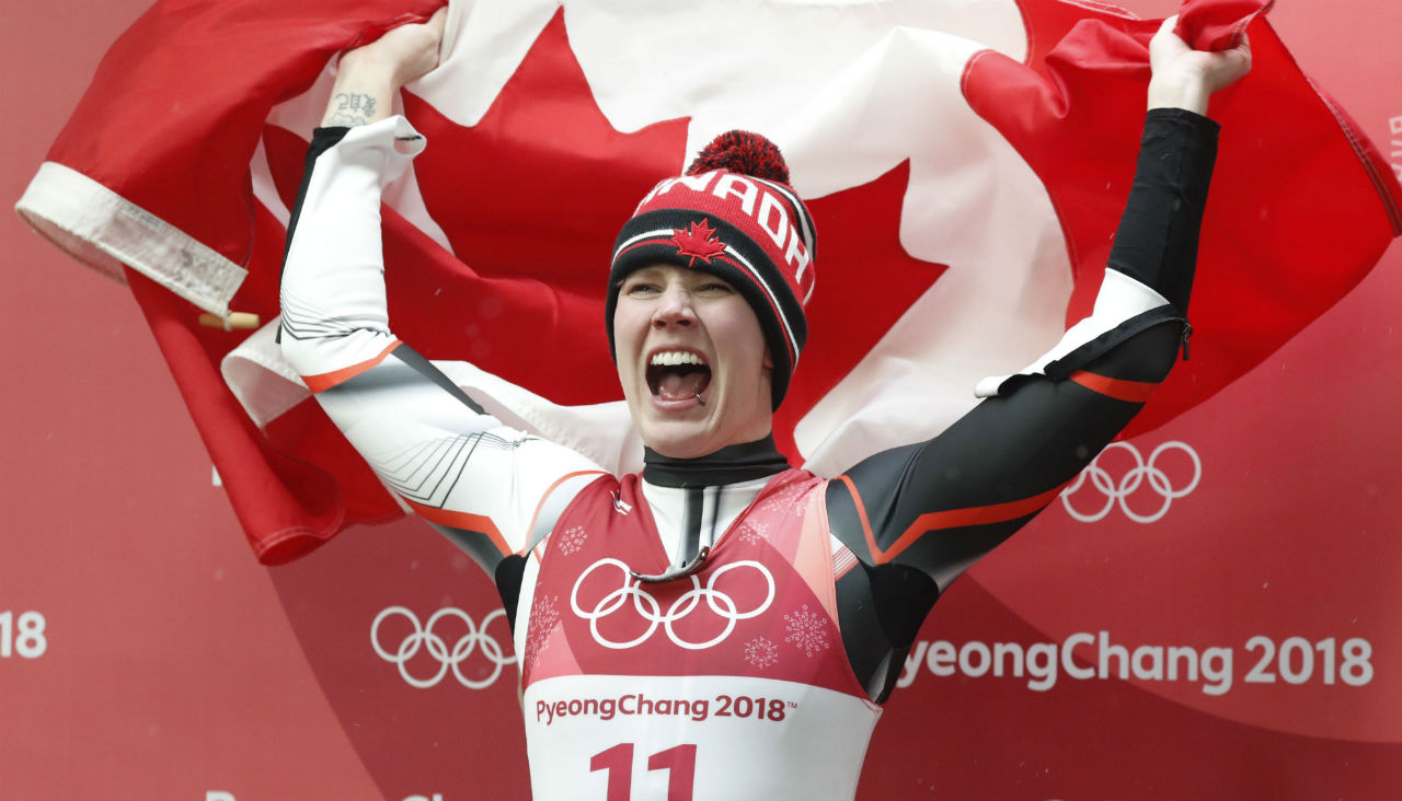 Third-placed-silver-medalist-Alex-Gough-of-Canada-waves-a-Canadian-flag-after-the-Women's-Luge-Singles-competition-at-the-Olympic-Sliding-Centre-during-the-PyeongChang-2018-Olympic-Games,-South-Korea,-13-February-2018.-EPA/JEON-HEON-KYUN