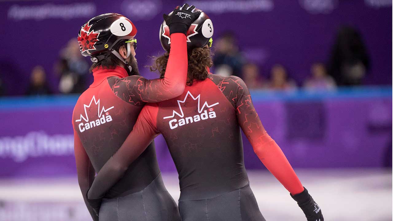 Canada's-Charles-Hamelin,-left,-and-teammate-Samuel-Girard
