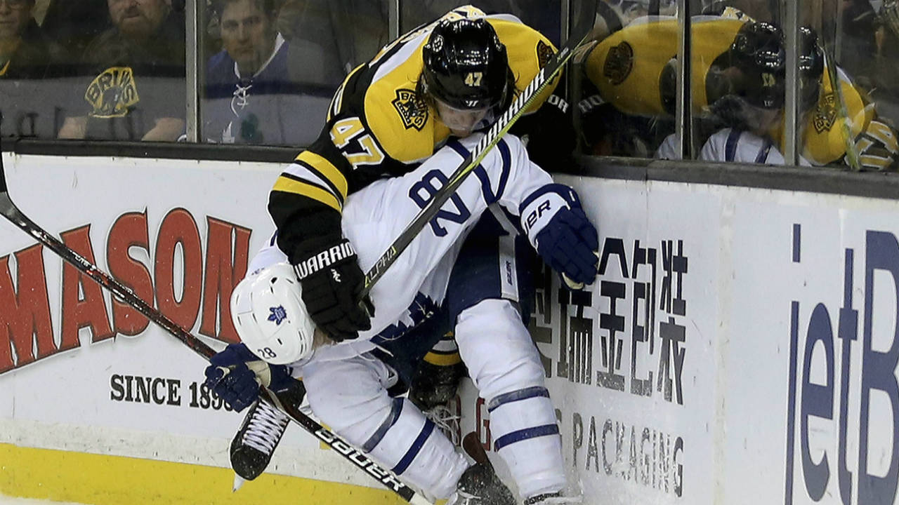 Toronto-Maple-Leafs-right-wing-Connor-Brown-(28)-and-Boston-Bruins-defenceman-Torey-Krug-(47)-crash-into-the-boards-in-pursuit-of-the-puck-during-the-first-period-of-an-NHL-hockey-game,-Saturday,-Feb.-3,-2018,-in-Boston.-(Mary-Schwalm/AP)