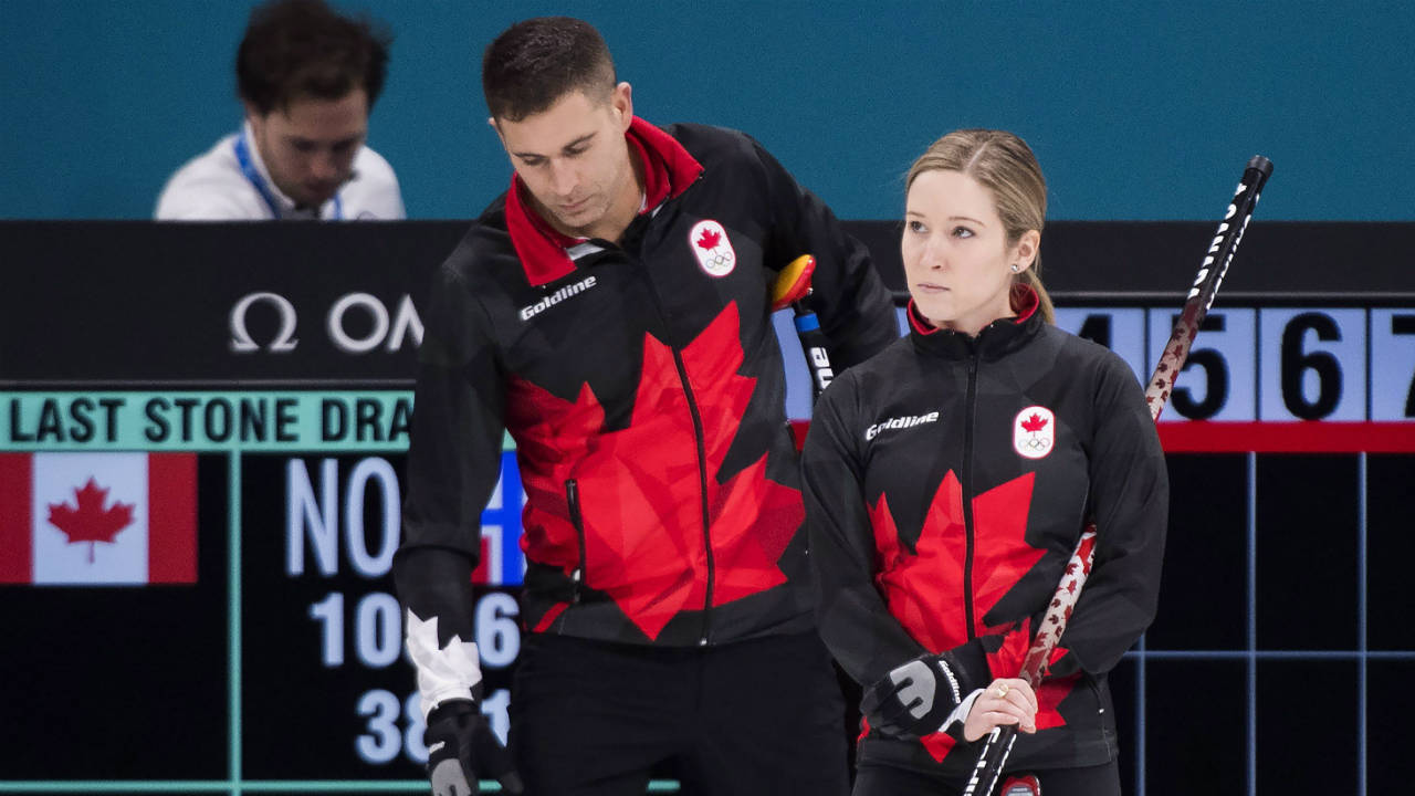 Canada's-Kaitlyn-Lawes,-left,-and-teammate-John-Morris-look-on-while-playing-against-Norway-during-mixed-doubles-curling-action-at-the-XXIII-Olympic-Winter-Games-in-Gangneung,-South-Korea-on-Thursday,-February-8,-2018.-Canada-lost-9-6.-(Nathan-Denette/CP)
