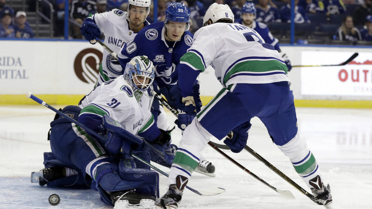 Vancouver-Canucks-goaltender-Anders-Nilsson-(31)-makes-a-pad-save-on-a-shot-by-Tampa-Bay-Lightning-center-Vladislav-Namestnikov-(90)-during-the-second-period-of-an-NHL-hockey-game-Thursday,-Feb.-8,-2018,-in-Tampa,-Fla.-Canucks-defenseman-Christopher-Tanev-(8)-looks-on.-(Chris-O'Meara/AP)