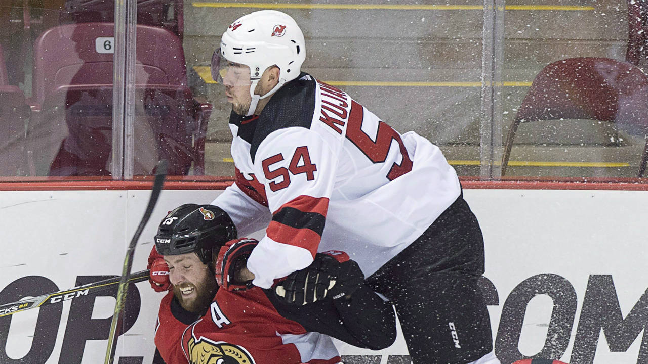 Ottawa-Senators-Zack-Smith-takes-a-hit-from-Ryan-Kujawinski,-right,-during-first-period-NHL-pre-season-hockey-action-in-Summerside,-P.E.I.-(Andrew-Vaughan/CP)