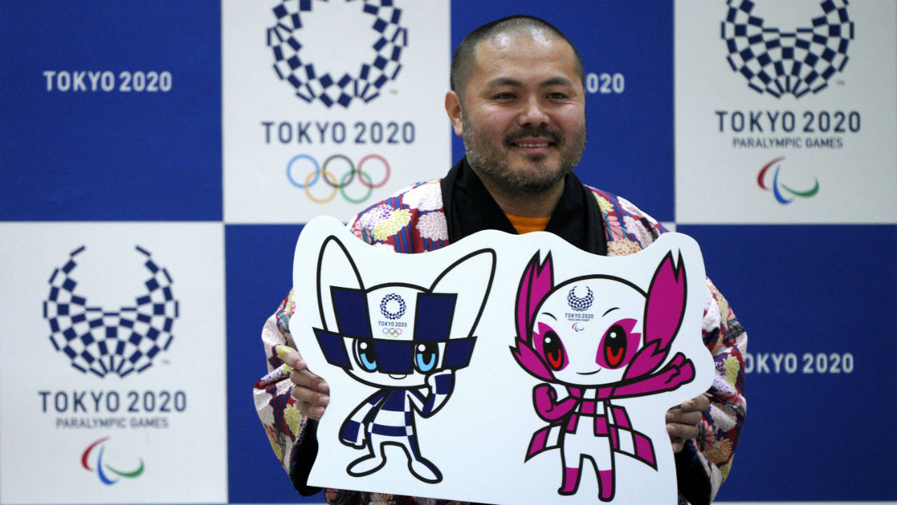 Ryo-Taniguchi,-the-designer-of-the-characters-which-will-serve-as-mascots-for-the-Tokyo-2020-Olympic-Games-and-Paralympics-Games,-poses-for-photographers-with-his-characters-during-a-press-conference-in-Tokyo,-Wednesday,-Feb.-28,-2018.-The-mascot-were-announced-after-a-vote-among-school-children-across-Japan.-(Eugene-Hoshiko/AP)