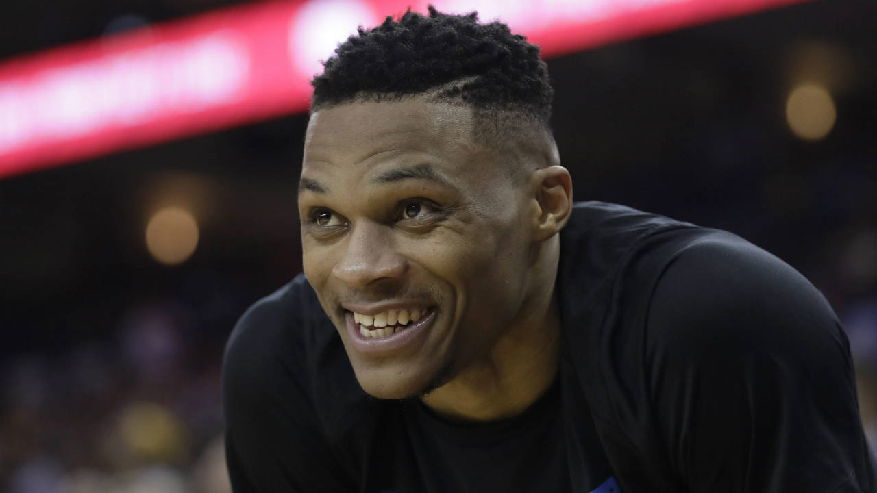 Oklahoma-City-Thunder's-Russell-Westbrook-smiles-from-the-bench-during-the-second-half-of-the-team's-NBA-basketball-game-against-the-Golden-State-Warriors-on-Tuesday,-Feb.-6,-2018,-in-Oakland,-Calif.-(Marcio-Jose-Sanchez/AP)