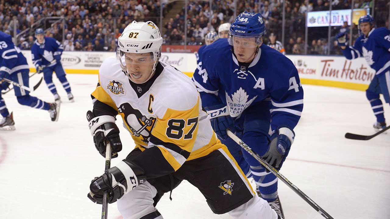 Pittsburgh-Penguins'-Sidney-Crosby-is-chased-into-the-corner-by-Toronto-Maple-Leafs'-Morgan-Rielly
