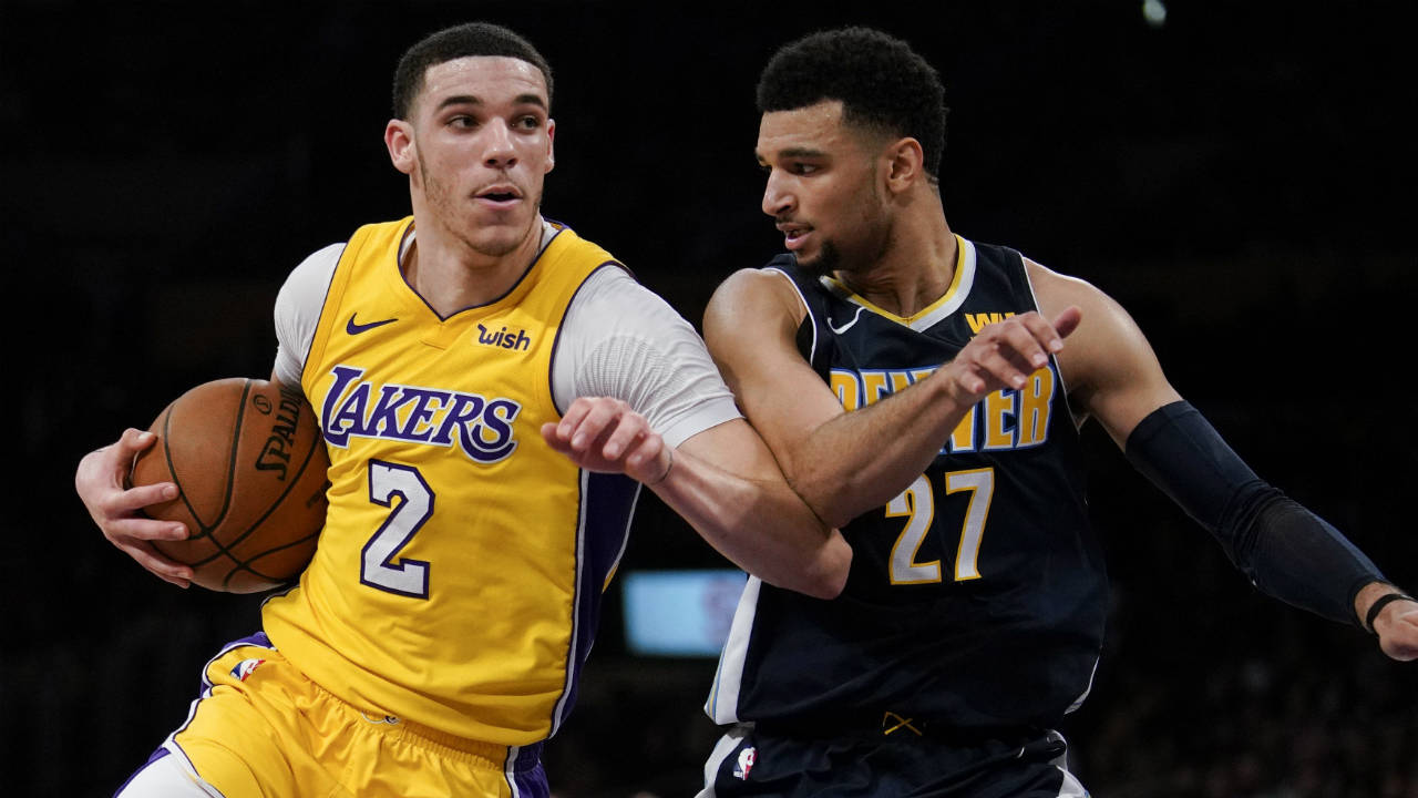 Los-Angeles-Lakers-guard-Lonzo-Ball,-left,-attempts-to-move-past-Denver-Nuggets-guard-Jamal-Murray-during-the-second-half-of-an-NBA-basketball-game-in-Los-Angeles,-Tuesday,-March-13,-2018.-Los-Angeles-defeated-Denver-112-103.-(Kelvin-Kuo/AP)
