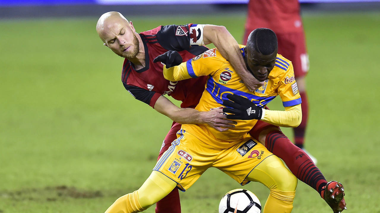 Toronto-FC-midfielder-Michael-Bradley-(4)-grabs-at-the-jersey-of-UANL-Tigres-forward-Enner-Valencia-(13)-as-they-vie-for-control-of-the-ball-during-first-half-CONCACAF-Champions-League-quarter-final-action,-in-Toronto-on-Wednesday,-March-7,-2018.-(Frank-Gunn/CP)