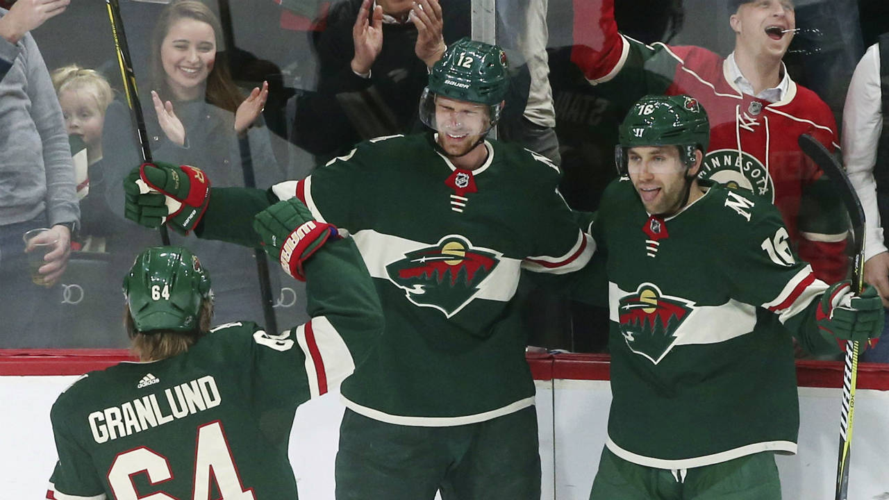 Minnesota-Wild's-Eric-Staal,-centre,-is-congratulated-by-Michael-Granlund,-left,-and-Jason-Zucker-after-Staal's-power-play-goal-off-Carolina-Hurricanes-goaltender-Cam-Ward-during-the-first-period-of-an-NHL-hockey-game-Tuesday,-March-6,-2018,-in-St.-Paul,-Minn.-(Jim-Mone/AP)