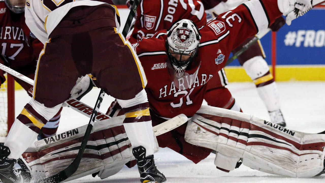 Harvard-goalie-Merrick-Madsen-(31)-blocks-a-shot-by-Minnesota-left-wing-Kyle-Osterberg-(8)-during-the-first-period-of-an-NCAA-Frozen-Four-men's-college-hockey-semifinal,-Thursday,-April-6,-2017,-in-Chicago.-(Nam-Y.-Huh/AP)