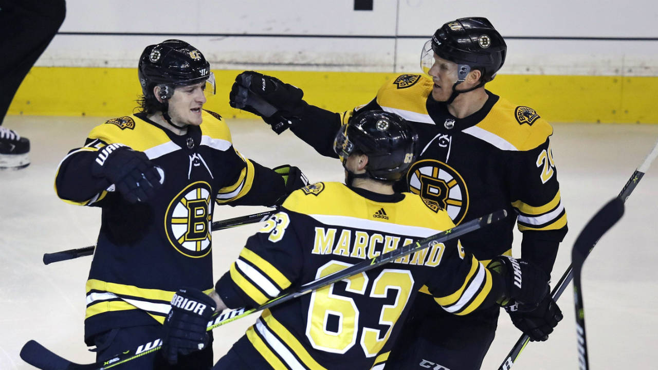 Boston-Bruins-defenceman-Torey-Krug,-left,-is-congratulated-by-Brad-Marchand-(63)-and-Riley-Nash,-right,-during-the-first-period-of-an-NHL-hockey-game-against-the-Detroit-Red-Wings-in-Boston,-Tuesday,-March-6,-2018.-(Charles-Krupa/AP)