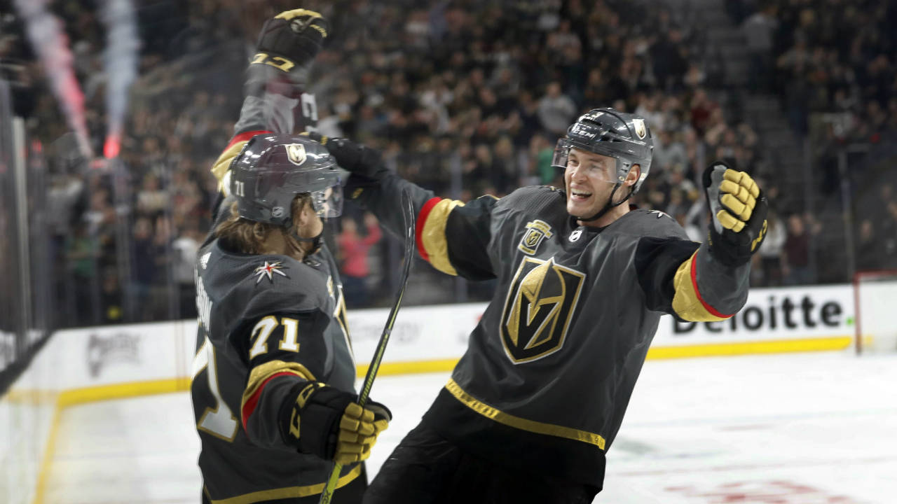 Vegas Golden Knights centre William Karlsson (71) celebrates with teammate Brayden McNabb (3) after scoring a hat trick during the second period of an NHL hockey game Sunday, March 18, 2018, in Las Vegas. (Steve Marcus/AP)