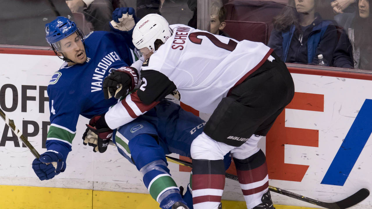 Arizona-Coyotes-defenceman-Luke-Schenn-(2)-puts-Vancouver-Canucks-defenceman-Michael-Del-Zotto-(4)-to-the-ice-during-second-period-NHL-action-in-Vancouver,-Wednesday,-March-7,-2018.-(Jonathan-Hayward/CP)