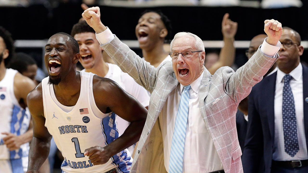 North-Carolina's-Theo-Pinson-(1)-and-coach-Roy-Williams.-(Gerry-Broome,-File/AP)