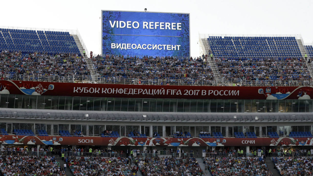 In-this-Sunday,-June-25,-2017-file-photo,-a-giant-screen-reports-an-incident-is-being-investigated-by-VAR-(Video-Assistant-Referee)-during-the-Confederations-Cup,-Group-B-soccer-match-between-Germany-and-Cameroon,-at-the-Fisht-Stadium-in-Sochi,-Russia.-Football‚Äôs-rules-making-panel-is-advising-FIFA-to-approve-video-review-technology-for-referees-before-the-World-Cup.-The-panel,-known-as-IFAB,-says-its-technical-experts-made-the-recommendation-Monday,-Jan.-22,-2018-ahead-of-a-March-2-meeting-at-FIFA-which-can-decide.-(Thanassis-Stavrakis,-file/AP)