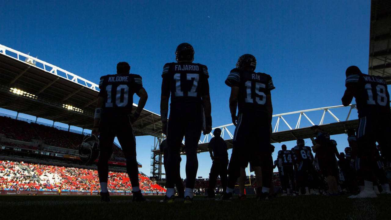 Players-stand-on-the-sidelines-as-the-Toronto-Argonauts-play-the-Hamilton-Tiger-Cats-during-the-first-half-of-CFL-football-preseason-action,-at-the-first-ever-CFL-football-game-played-at-BMO-Field,-in-Toronto-on-June-11,-2016.-This-season-Toronto-Argonauts-fans-can-expect-lower-ticket-prices,-tailgating-inside-the-stadium-and-branding-focused-on-the-team's-roots-as-a-rowing-club.-The-changes-announced-Monday-are-part-of-owner-Maple-Leaf-Sports-and-Entertainment's-ambitious-efforts-to-revamp-the-Argos-and-after-years-of-attendance-woes,-build-the-team-a-fanbase-as-large-and-rabid-as-the-Toronto-Maple-Leafs',-Toronto-Raptors'-and-Toronto-FC's.-(Mark-Blinch/CP)