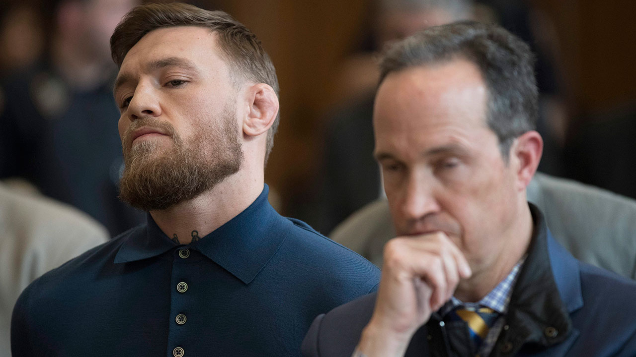 Conor-McGregor,-left,-stands-with-his-lawyer-Jim-Walden-during-his-arraignment-in-Brooklyn-Criminal-Court