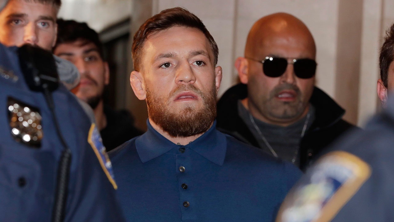 UFC-star-Conor-McGregor-seen-here-being-escorted-by-New-York-Court-Police-officers-after-a-hearing-at-the-Brooklyn-Criminal-Court-on-Friday,-April-6,-2018.