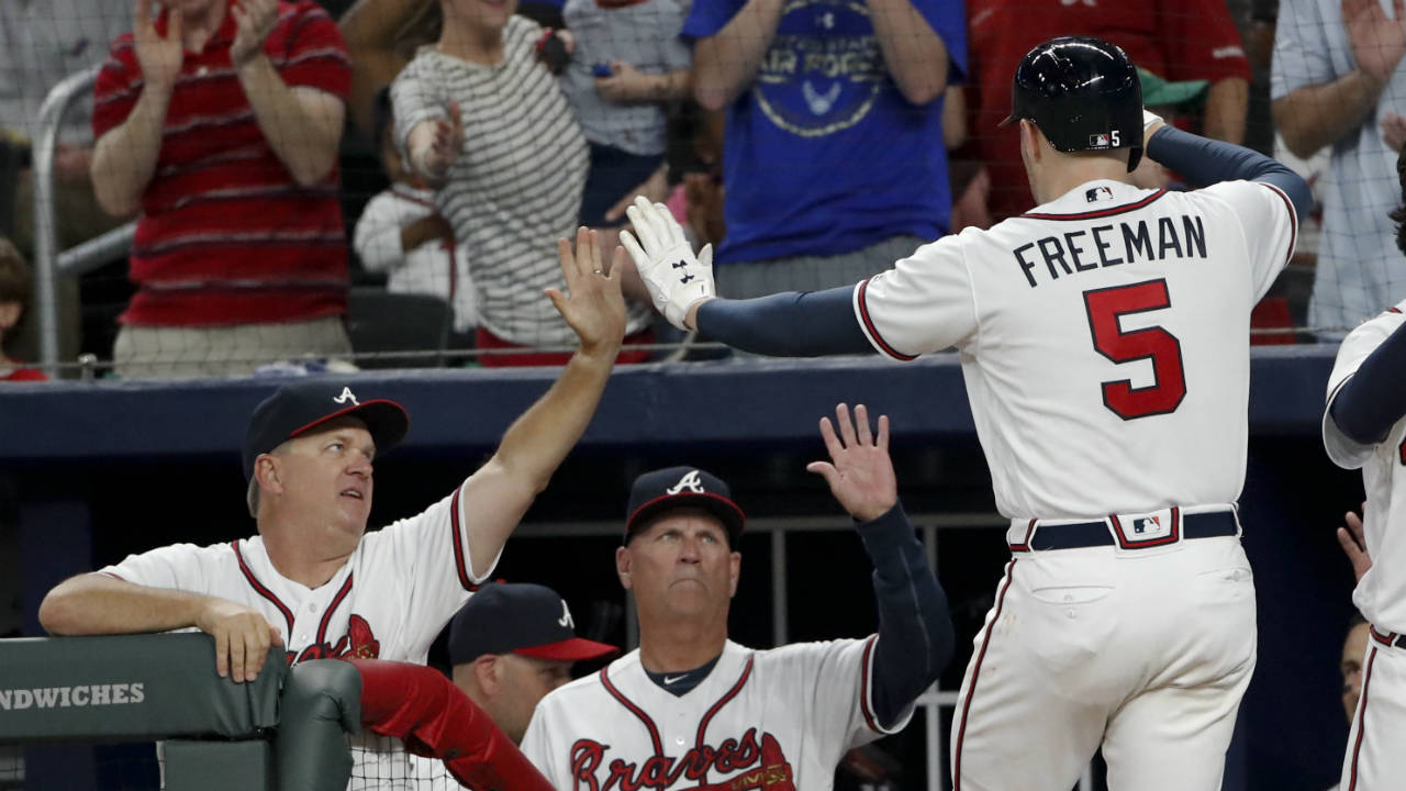 Atlanta-Braves'-Freddie-Freeman-(5)-is-greeted-at-the-dugout-by-hitting-coach-Kevin-Seitzer,-left,-and-manager-Brian-Snitker-after-hitting-a-three-run-home-run-during-the-second-inning-of-the-team's-baseball-game-against-the-Washington-Nationals-on-Tuesday,-April-3,-2018,-in-Atlanta.-(John-Bazemore/AP)