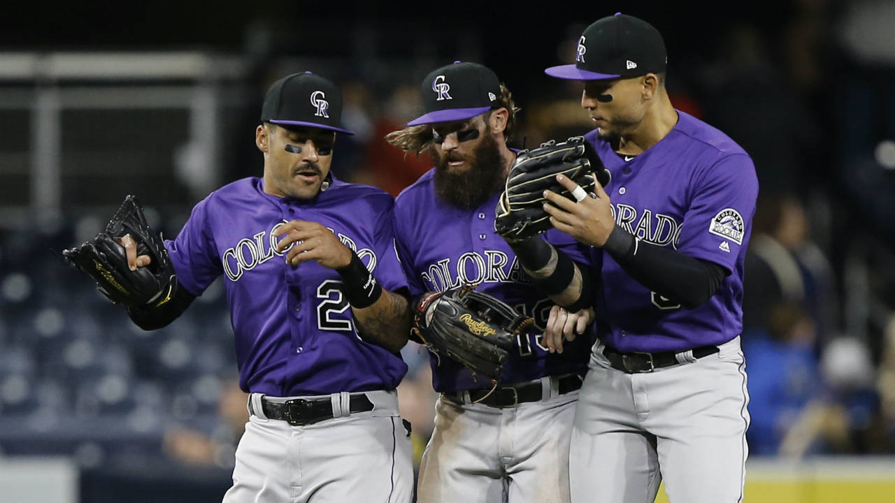 Colorado-Rockies-outfielders-Ian-Desmond,-left,-Charlie-Blackmon,-centre,-and-Carlos-Gonzalez-leap-in-celebration-of-the-Rockies'-5-2-win-over-the-San-Diego-Padres-in-a-baseball-game-in-San-Diego,-Wednesday,-April-4,-2018.-(Alex-Gallardo/AP)