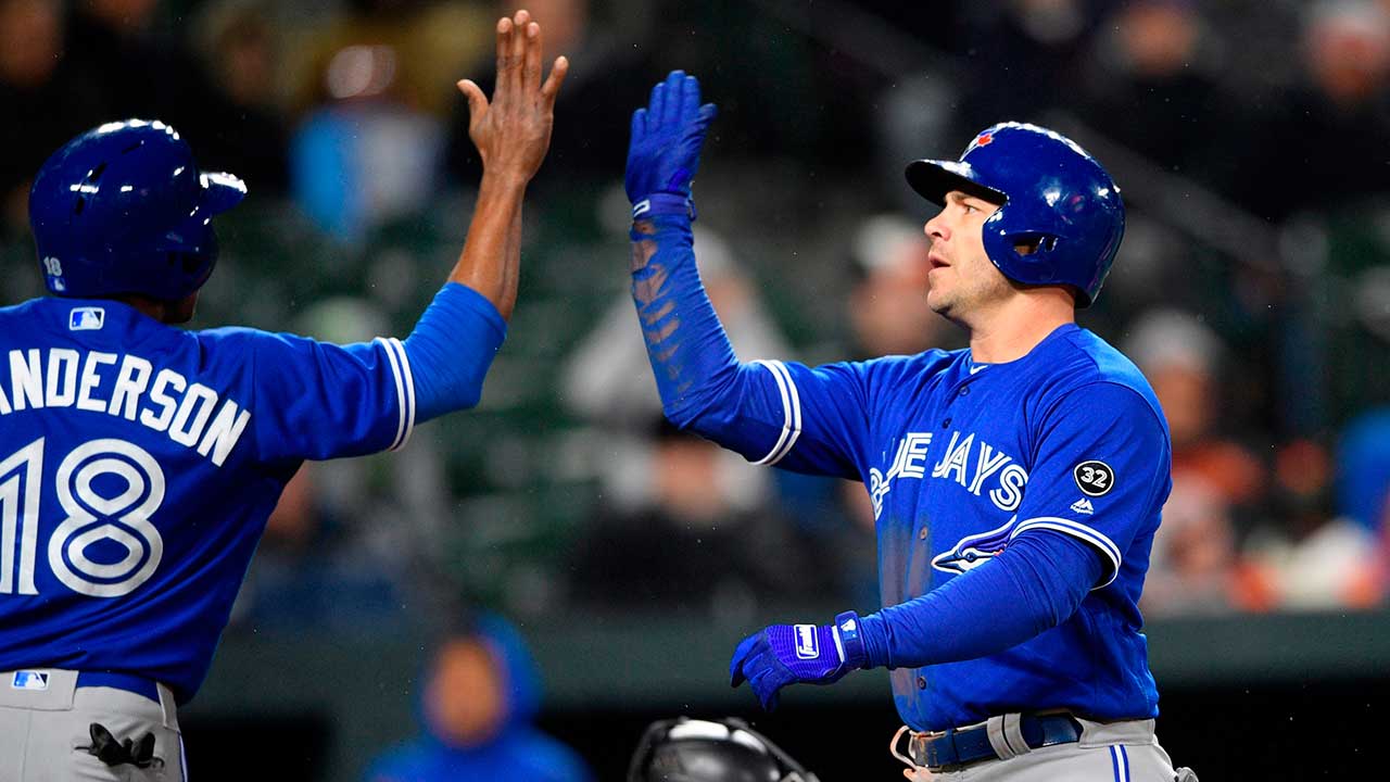 Toronto-Blue-Jays'-Steve-Pearce,-right,-celebrates-his-two-run-home-run-with-Curtis-Granderson