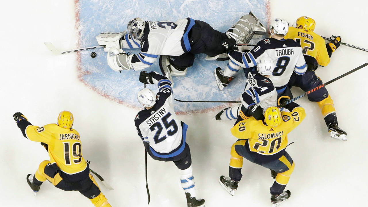 Winnipeg-Jets-goalie-Connor-Hellebuyck,-top,-blocks-a-shot-as-Nashville-Predators-center-Calle-Jarnkrok-(19),-of-Sweden,-watches-for-the-rebound-during-the-first-period-in-Game-1-of-an-NHL-hockey-second-round-playoff-series-Friday,-April-27,-2018,-in-Nashville,-Tenn.-(Mark-Humphrey/AP)