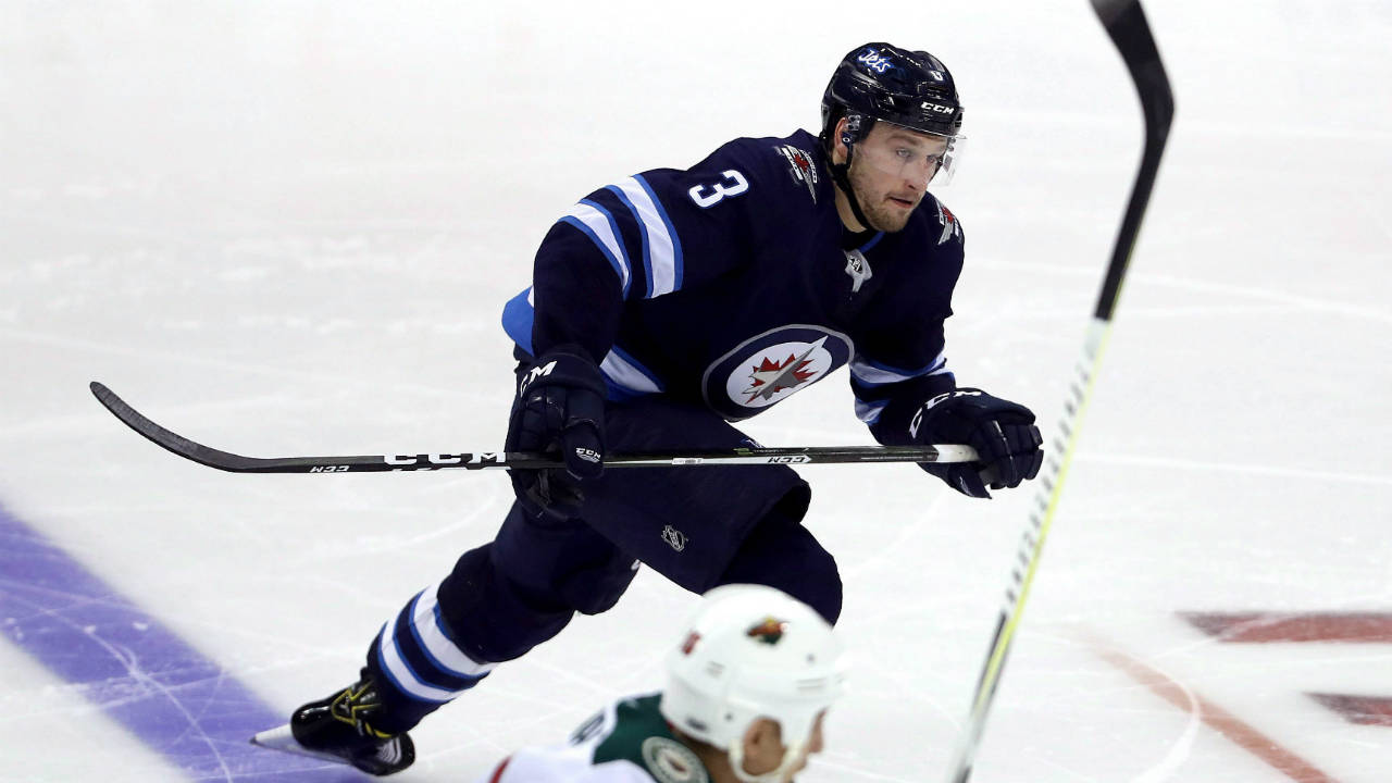 Winnipeg-Jets-defenceman-Tucker-Poolman-(3)-skates-up-ice-while-playing-against-the-Minnesota-Wild-during-third-period-NHL-preseason-hockey-action-in-Winnipeg,-Monday,-September-18,-2017.-(Trevor-Hagan/CP)