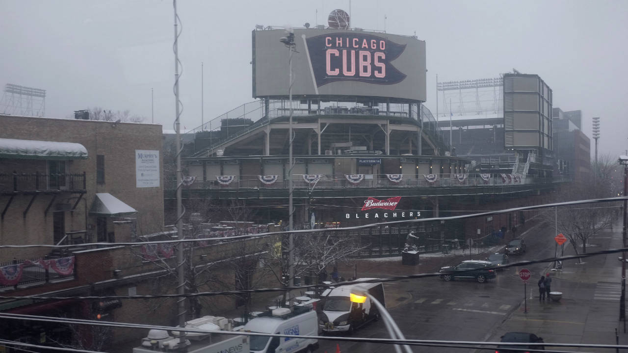 Snow-falls-at-Wrigley-Field-on-the-morning-of-Chicago's-home-opener-baseball-game-against-the-Pittsburgh-Pirates,-Monday,-April-9,-2018,-in-Chicago.-(Kiichiro-Sato/AP)