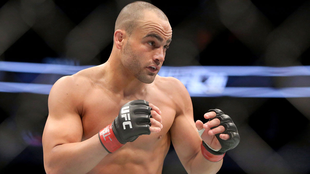 Former-UFC-lightweight-champion-Eddie-Alvarez-stands-in-the-cage-with-his-hands-ready.
