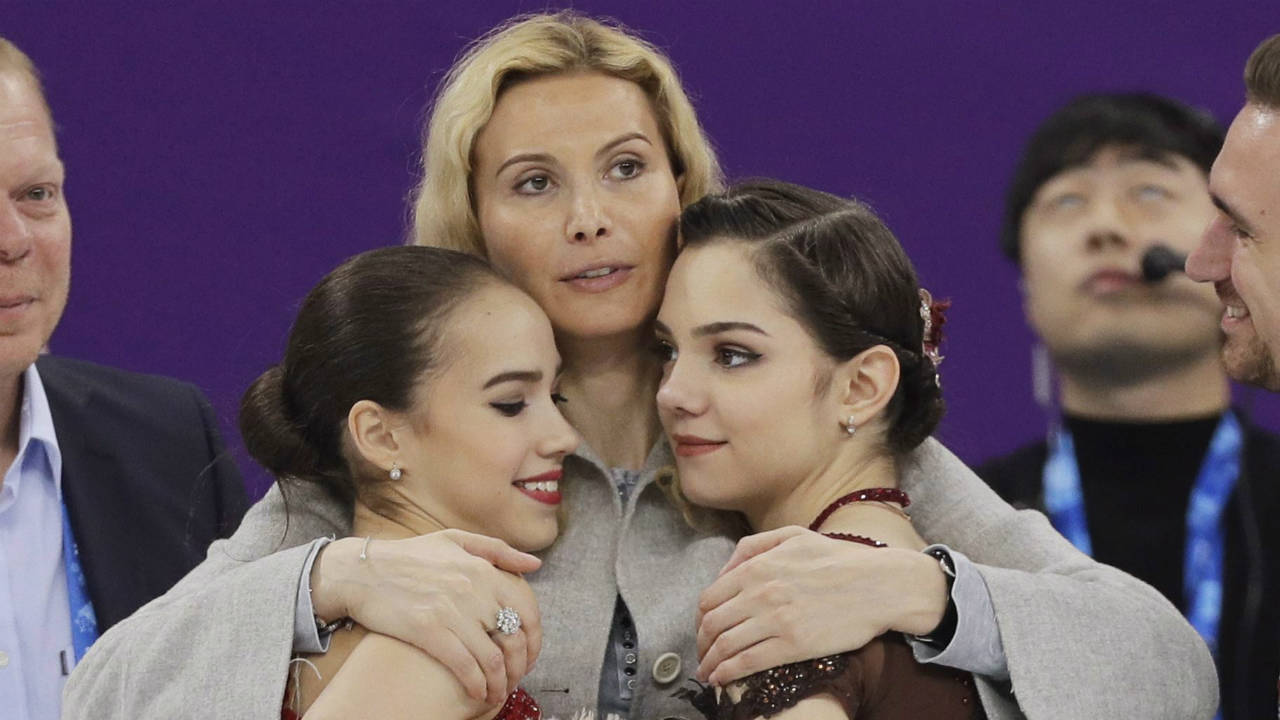Gold-medalist-Alina-Zagitova,-left,-of-the-Olympic-Athletes-of-Russia-and-compatriot-and-silver-medalist-Evgenia-Medvedeva,-right,-are-embraced-by-coach-Eteri-Georgievna-Tutberidze-at-the-women's-free-figure-skating-final-in-the-Gangneung-Ice-Arena-at-the-2018-Winter-Olympics-in-Gangneung,-South-Korea,-Friday,-Feb.-23,-2018.