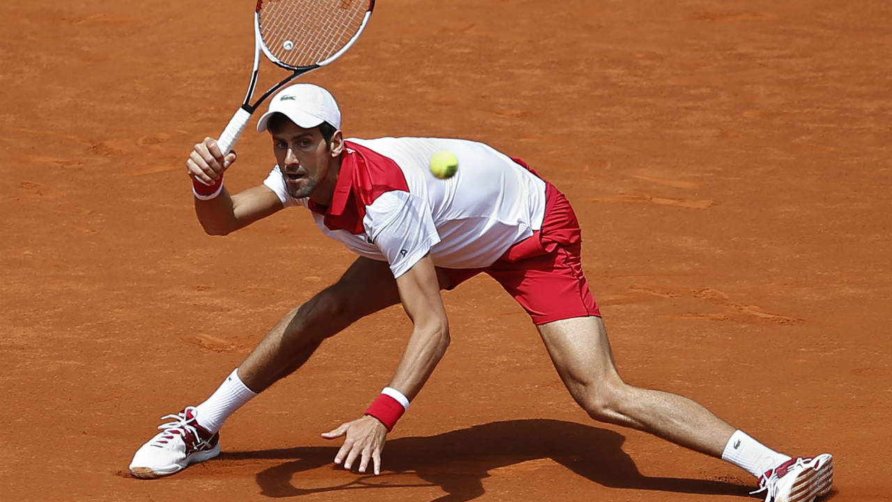 Novak-Djokovic-of-Serbia-returns-the-ball-to-Kyle-Edmund-of-Britain-during-the-Madrid-Open-Tennis-tournament-in-Madrid,-Spain,-Wednesday,-May-9,-2018.-(Paul-White/AP)