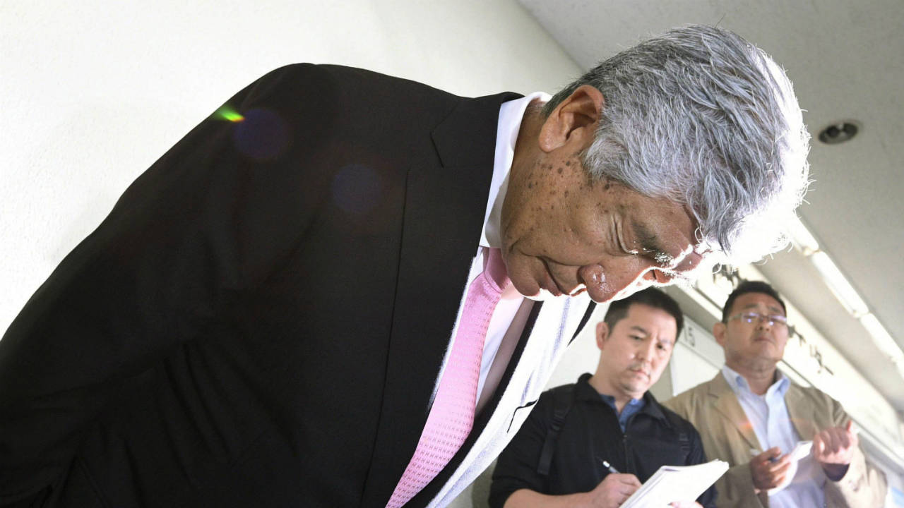 Nihon-University-head-coach-Masato-Uchida-apologizes-as-he-speaks-to-reporters-at-Osaka-International-Airport-in-Osaka,-western-Japan-Saturday,-May-19,-2018.-Uchida-said-he-would-resign-to-take-responsibility-for-the-hit-in-which-one-of-his-players-tackled-Kwansei-Gakuin's-quarterback-from-behind-long-after-he-had-released-the-ball.