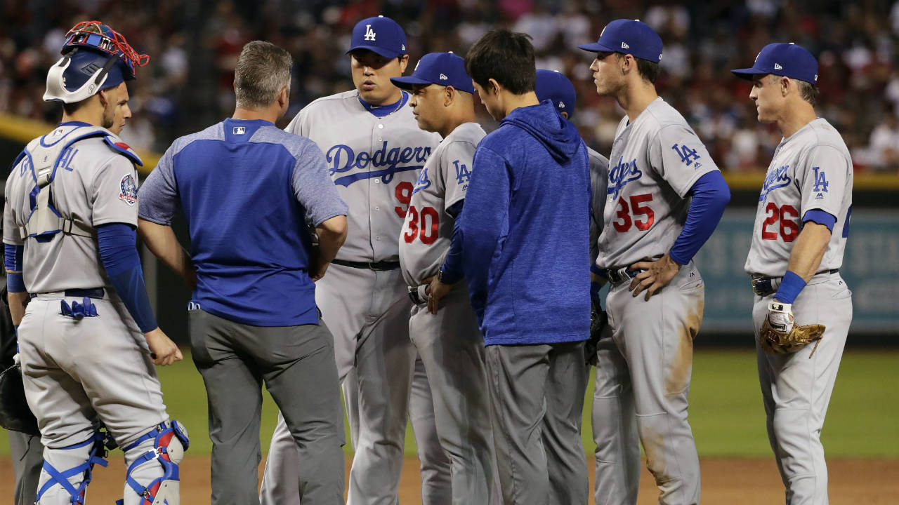 Los-Angeles-Dodgers-starting-pitcher-Hyun-Jin-Ryu,-centre,-talks-with-a-trainer-after-an-injury-during-the-first-inning-of-the-team's-baseball-game-against-the-Arizona-Diamondbacks-on-Wednesday,-May-2,-2018,-in-Phoenix.-Ryu-left-the-game.-(Matt-York/AP)