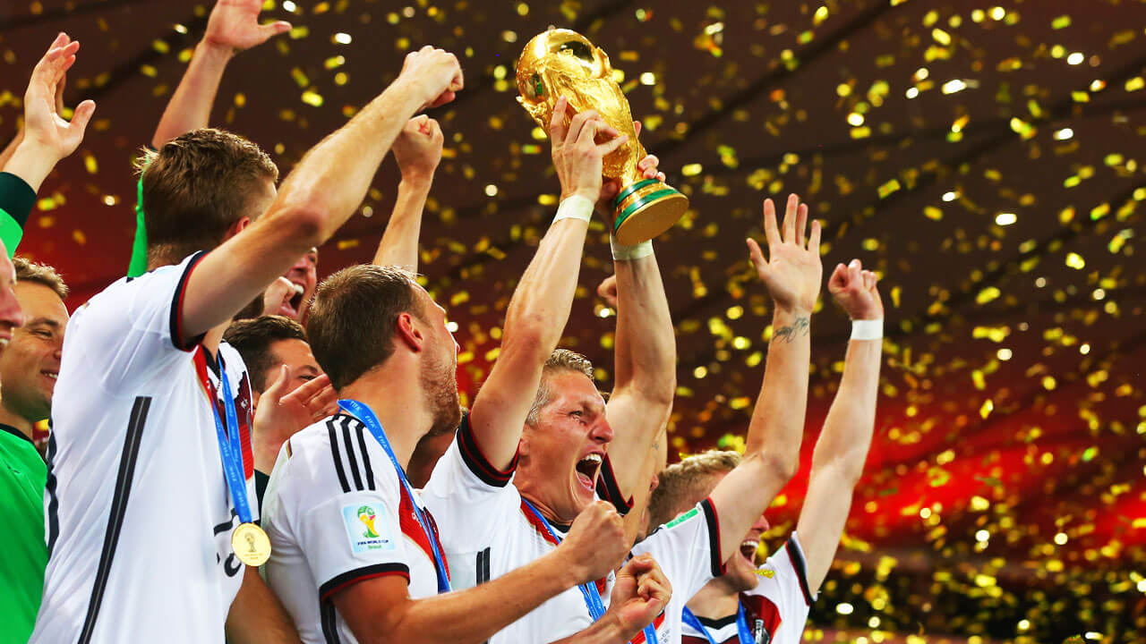 Germany's-Bastien-Schweinsteiger-lifts-World-Cup-trophy-teammates-in-Rio-de-Janeiro