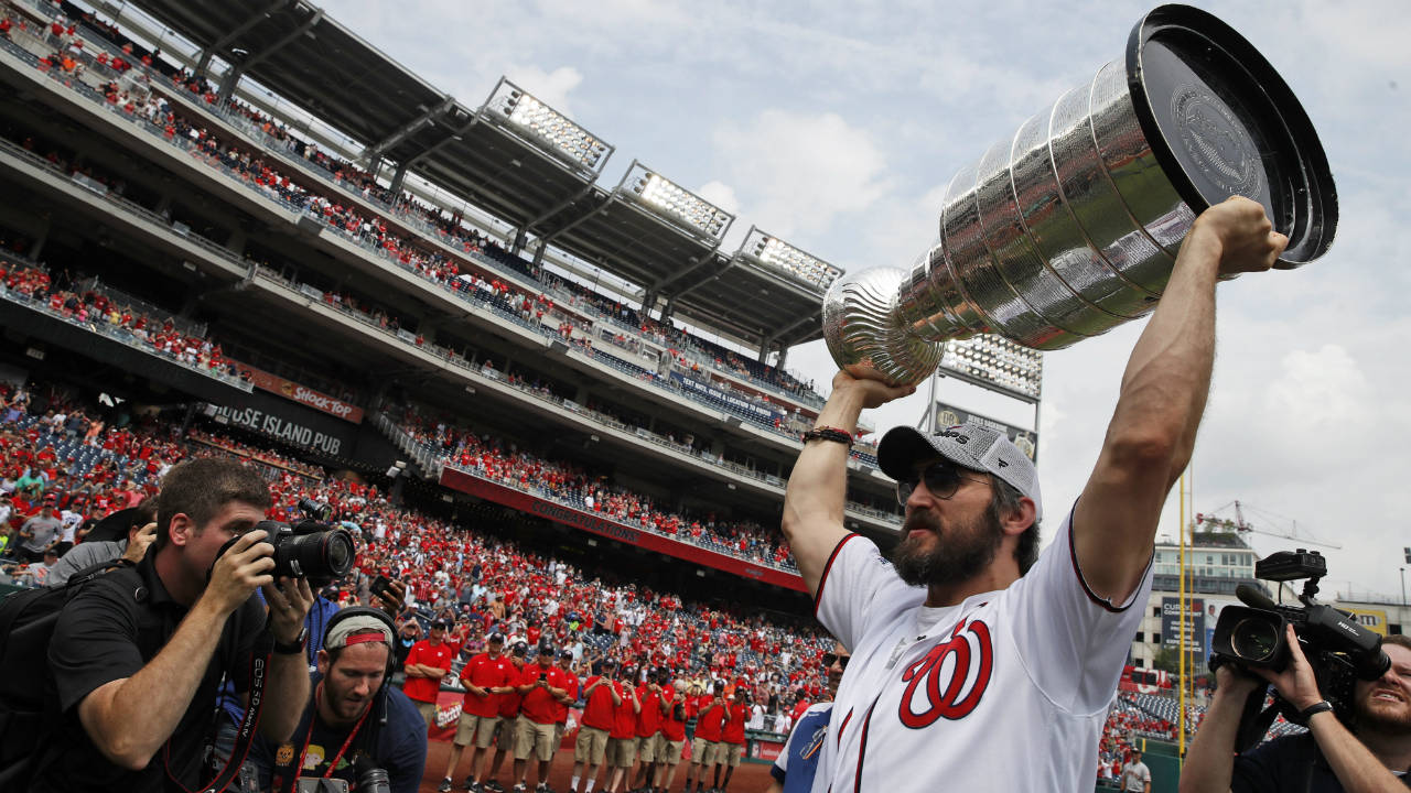 Washington-Capitals'-Alex-Ovechkin,-from-Russia,-lifts-the-Stanley-Cup-on-the-field-before-a-baseball-game-between-the-Washington-Nationals-and-the-San-Francisco-Giants-at-Nationals-Park,-Saturday,-June-9,-2018,-in-Washington.-(Alex-Brandon/AP)