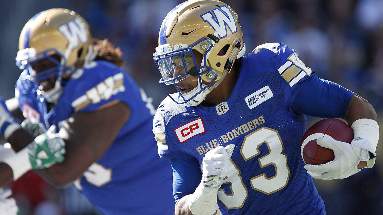 andrew-harris-runs-the-ball-follows-blocks-blue-bombers