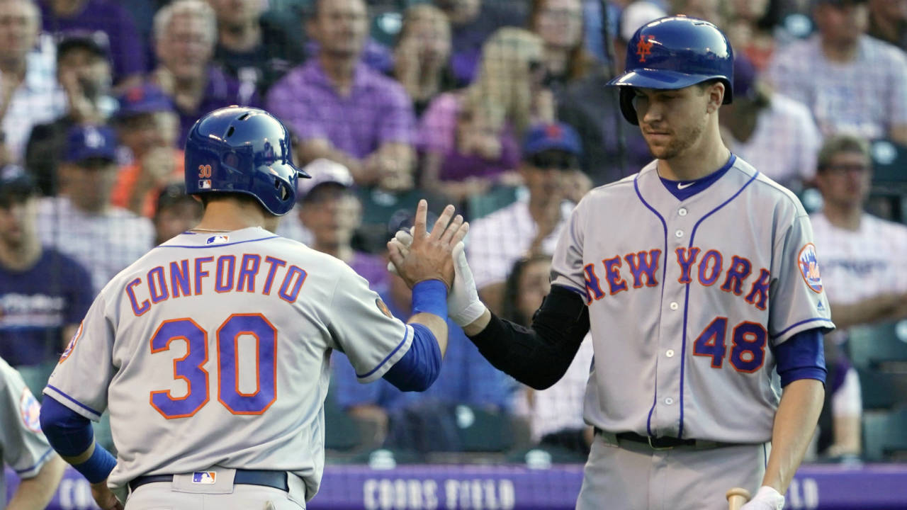 New-York-Mets'-Michael-Conforto-(30)-is-congratulated-by-teammate-Jacob-deGrom-(48)-after-scoring-a-run-against-the-Colorado-Rockies-during-the-second-inning-of-a-baseball-game,-Monday,-June-18,-2018,-in-Denver.