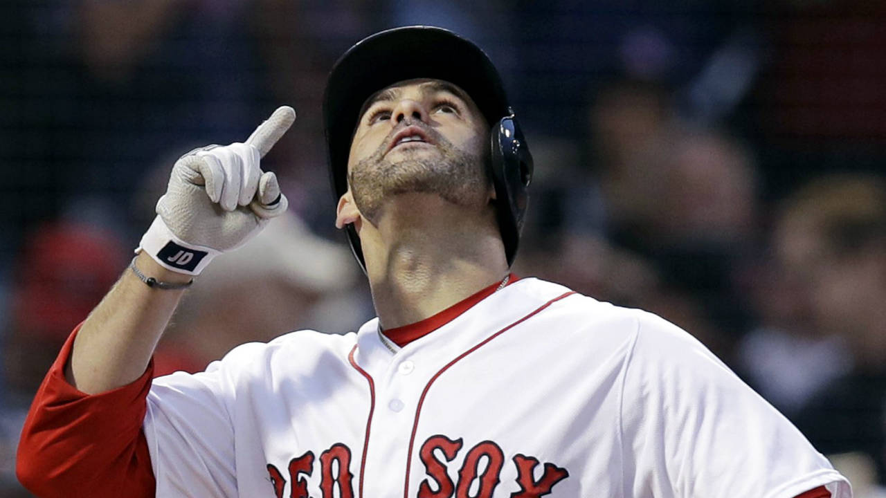 Boston-Red-Sox's-J.D.-Martinez-points-upward-as-he-crosses-home-plate-after-belting-a-three-run-home-run-off-Los-Angeles-Angels-starting-pitcher-Andrew-Heaney-during-the-second-inning-of-a-baseball-game-at-Fenway-Park-in-Boston,-Wednesday,-June-27,-2018.