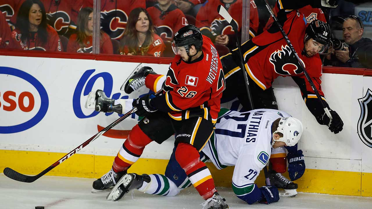 flames-tyler-wotherspoon-fights-for-the-puck-against-the-vancouver-canucks