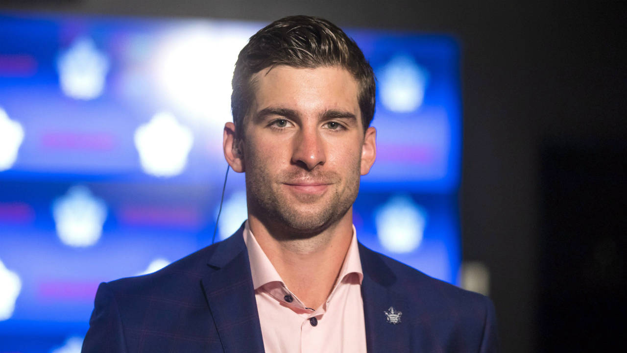 John-Tavares-prepares-to-do-a-television-interview-following-a-news-conference-in-Toronto-after-signing-with-the-Toronto-Maple-Leafs-on-Sunday,-July-1,-2018.