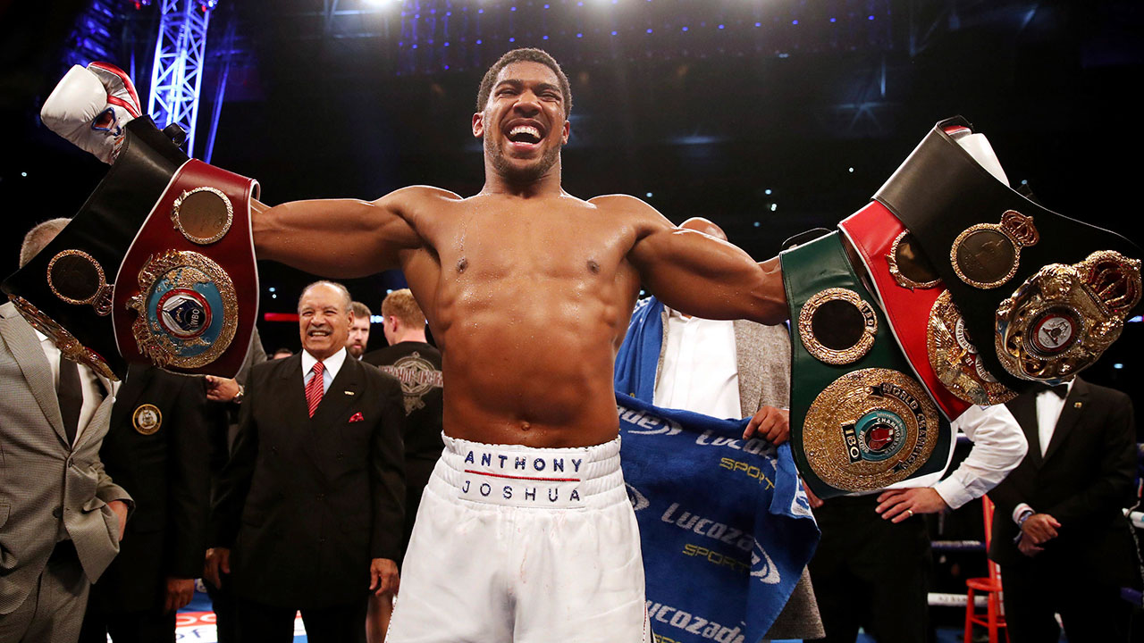 anthony-joshua-celebrates-with-title-belts
