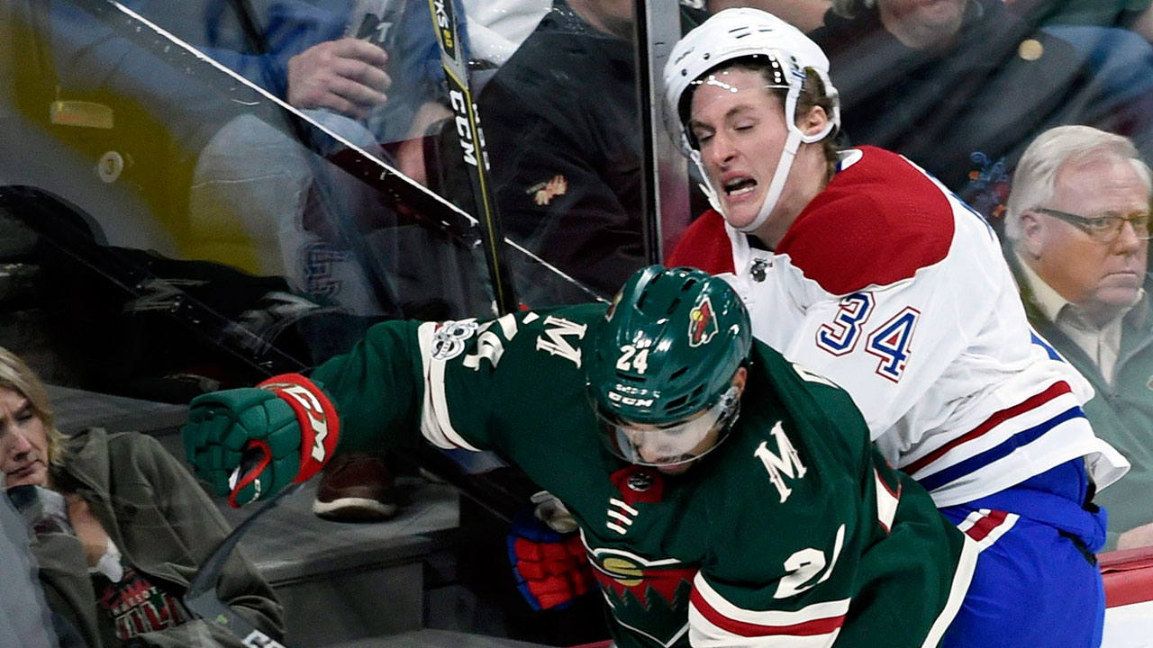michael_mccarron_gets_checked_against_the_minnesota_wild