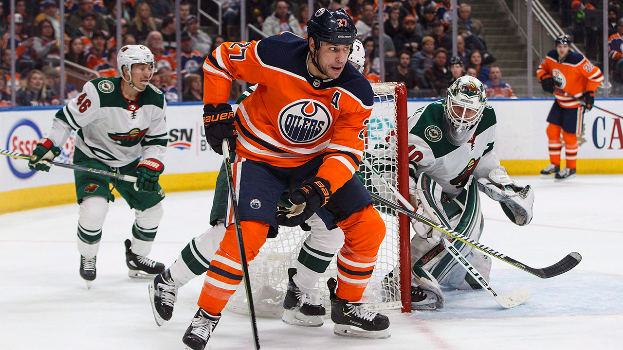 oilers-milan-lucic-takes-puck-around-wild-net