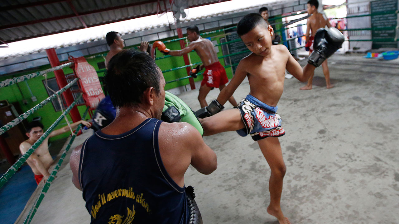 child-Thai-boxer-training-kicks-at-gym