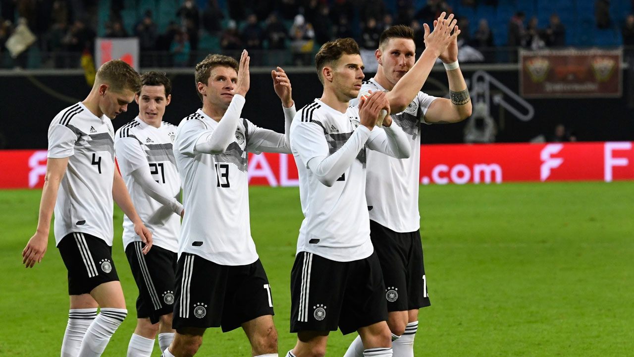 Germany's Niklas Suele, Leon Goretzka,Thomas Mueller, Sebastian Rudy and Matthias Ginter, from right, claps hands to supporters after winning a friendly soccer match between Germany and Russia. (Jens Meyer/AP)