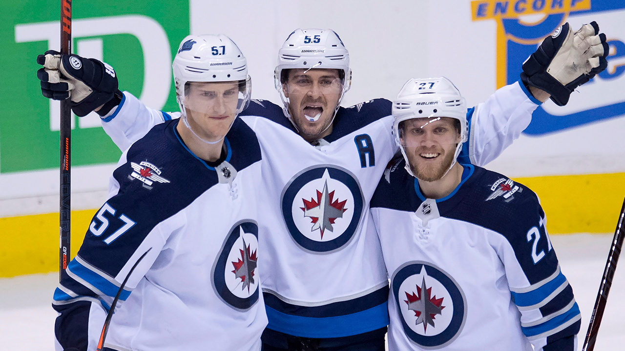 Winnipeg Jets centre Mark Scheifele (55) celebrates his goal with teammates Tyler Myers (57) and Nikolaj Ehlers (27). (Jonathan Hayward/CP)