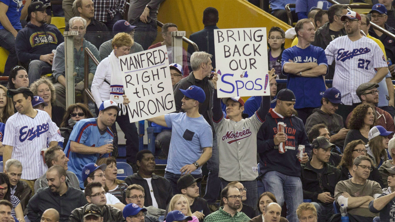 Fans-hold-up-signs-as-the-Toronto-Blue-Jays-face-the-Cincinnati-Reds-in-Grapefruit-League-play-on-April-3,-2015-in-Montreal.