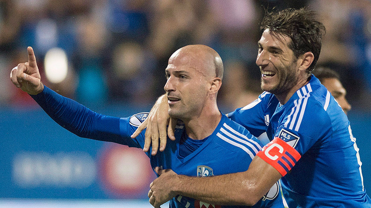 Laurent Ciman celebrates with Impact teammate Ignacio Piatti after scoring. (Graham Hughes/CP)