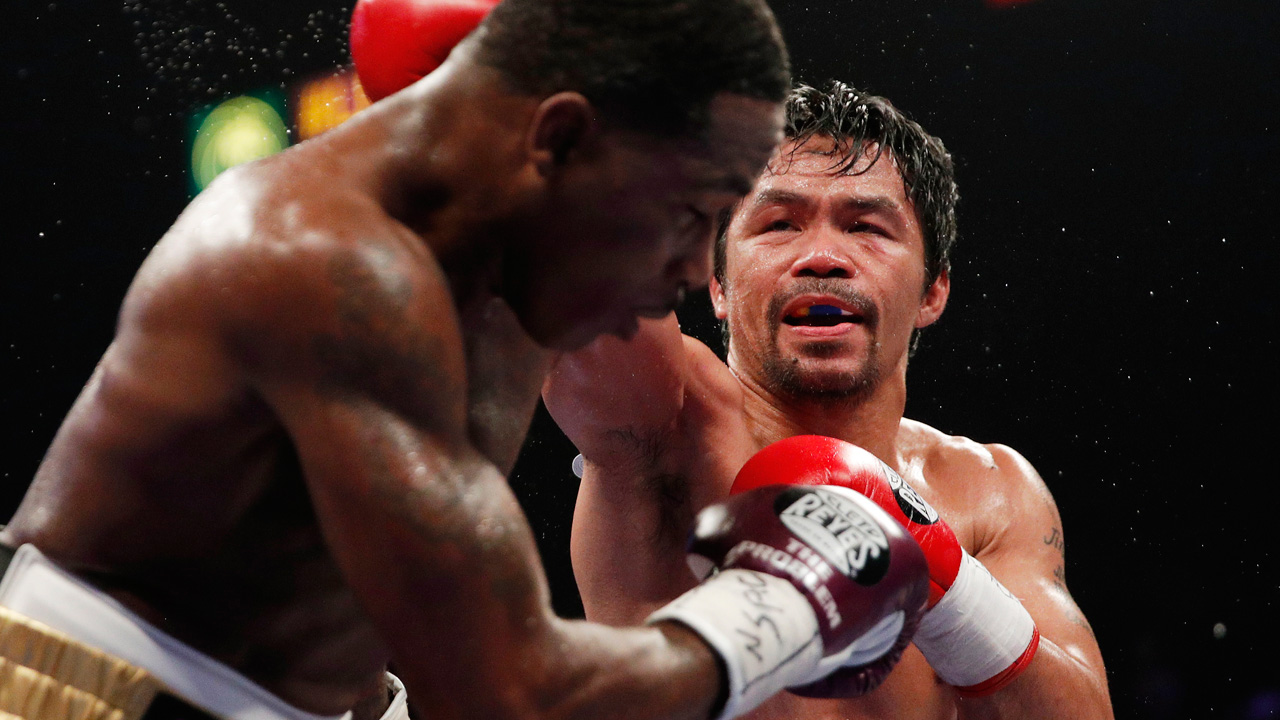 Manny Pacquiao, right, hits Adrien Broner during a WBA welterweight title match in Las Vegas. (John Locher/AP)