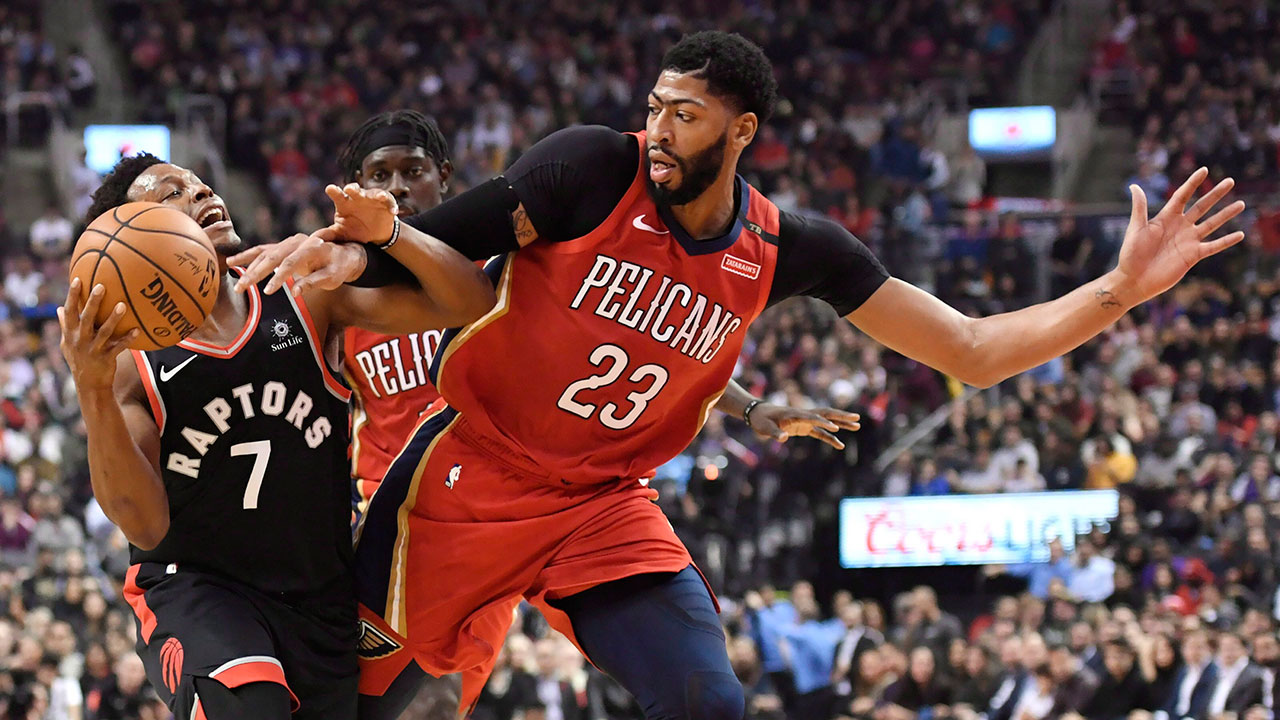 NBA-Raptors-Lowry-drives-against-Pelicans-Davis