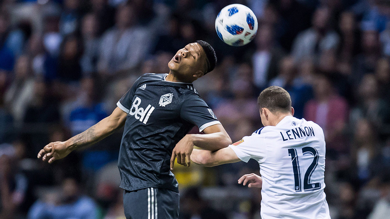 anthony-blondell-heads-the-ball-ahead-of-brooks-lennon